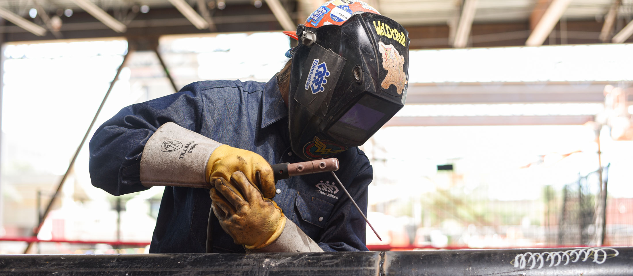 Kaylin Leas Welding a pipe.